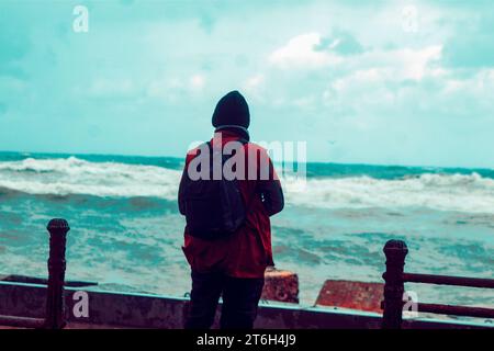 back view for unrecognizable person looking ahead to the sea Stock Photo