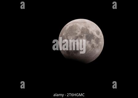 The shallow partial lunar eclipse of October 28-29, 2023, was visible from Europe, Africa, most of Asia and western Australia. Only 6% of the moon was Stock Photo