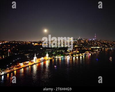 A breathtaking view of the dark night sky filled with twinkling stars above a sprawling cityscape Stock Photo