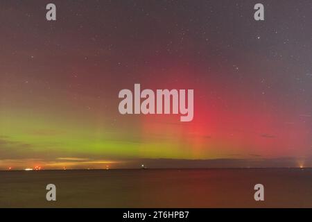 A rare vibrant display of the Aurora Borealis (Northern Lights) photographed above the North Kent coast at Herne Bay, Kent in SE England. Stock Photo