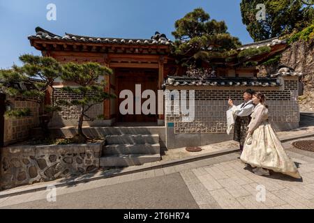 Couple in traditional dress, selfie in Hanok village, South Korea Stock Photo