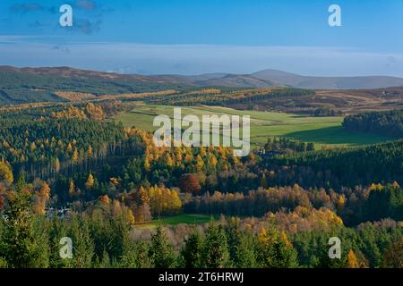 Balmoral Estates Crathie Scotland looking across the valley to estate houses and Lochnagar Distillery with autumnal colours in the trees and leaves Stock Photo