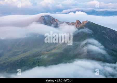 Italy, Veneto, province of Belluno, Livinallongo, on the left the Col di Lana and on the right the Mount Sief, the scene of battles during the First World War, emerging from the fog, Dolomites Stock Photo