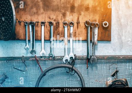 Wrenches hanging on an old stand in a locksmith's shop Stock Photo