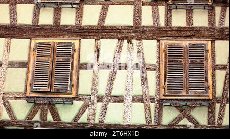 Half-timbered house wall with closed shutters in Kaysersberg, Alsace Stock Photo
