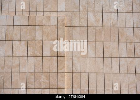 Pattern and texture. Beige, color building wall  architecture facade. Sunny day. Vertical and horizontal lines. Greece Thessaloniki Greece 2023. Stock Photo