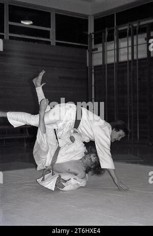 1970s, judo, male competitors grappling each other on a mat in a sports hall. The Japanese martial art of Judo is a tough physical sport, involving numerous moves, but one which also demands strong mental discipline, concentration and resilience. A key factor in judo is one of respect, for your opponent and yourself. Stock Photo