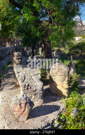 Heads carved into rocks at Enchanted Castle, Sciacca, Agrigento district, Sicily, Italy Stock Photo