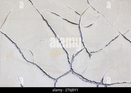 Wall, cracks in plaster, peeling old paint, wallpaper Stock Photo
