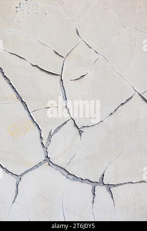 Wall, cracks in plaster, peeling old paint, wallpaper Stock Photo