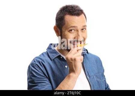 Happy young man eating tortilla chips isolated on white background Stock Photo