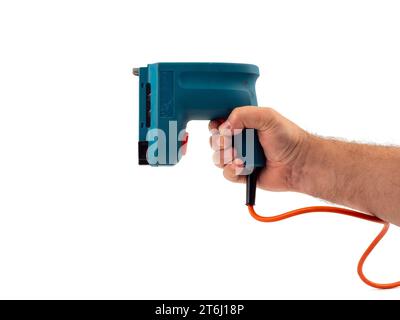 Electric stapler on a white background. Electric staple gun close-up. Stock Photo