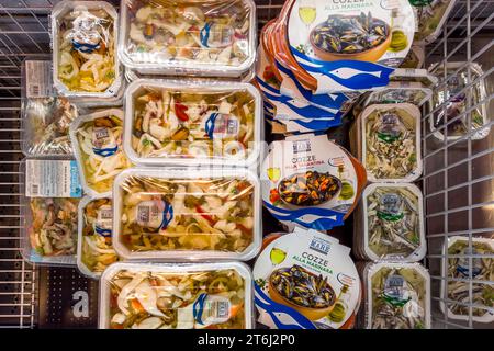 Italy - November 09, 2023: Fish shellfish and mussels precooked and packaged in refrigerated counter for sale in Italian supermarket Stock Photo