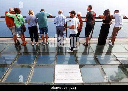 Tourists enjoy the view from the glass-bottom skywalk, Cabo Girao, Camara de Lobos, Madeira Island, Portugal Stock Photo