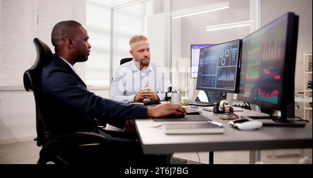 African American Data Analyst Using Data Analytics KPI Dashboard Stock Photo