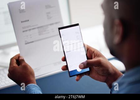 Taking a Photo of an Invoice Document Using Phone Stock Photo