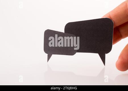 Hand holding dialogue boxes on a white background Stock Photo