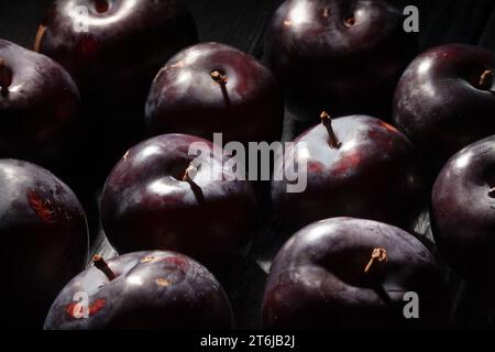 red plum on wood background Stock Photo