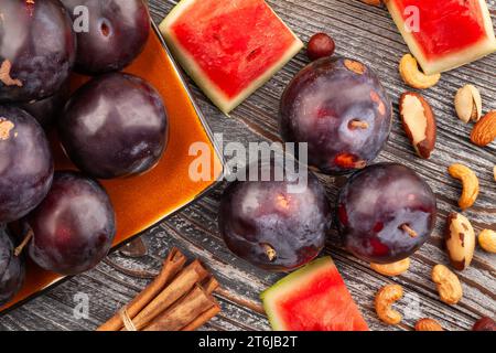 red plum on wood background Stock Photo