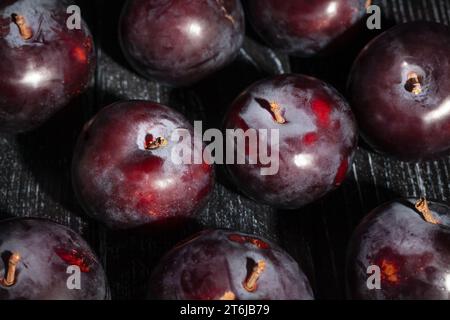 red plum on wood background Stock Photo