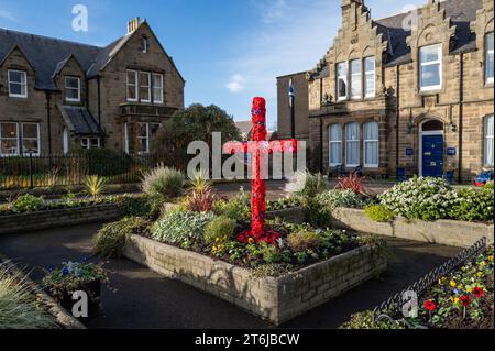 Cluny Square, Buckie, Moray, UK. 10th Nov, 2023. This is the Remembrance displays in this bustling town, with Red Poppies, Soldiers Hat and Boots and a large Cross with poppies to remember Soldiers, Horses, Dogs and other animals lost in the wars. Credit: JASPERIMAGE/Alamy Live News Stock Photo