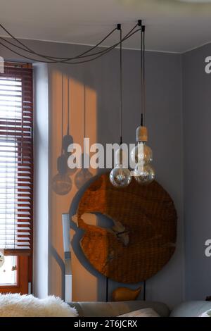 Modern interior lights. Minimalist house design. Three lightbulbs next to each other suspended in different heights Stock Photo