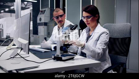 Electronic Lab Factory Worker And Semiconductor Engineer Testing Device Stock Photo