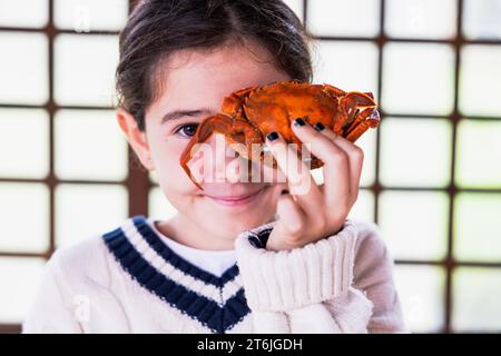 Portrait of a girl playing fun hiding her eyes behind a blackberry. Stock Photo