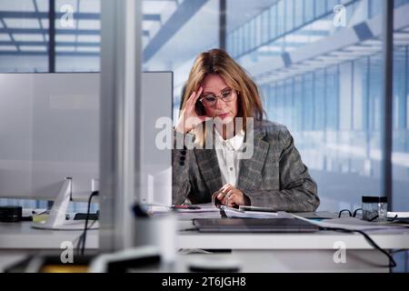 Unhappy, Tired Employee: Stressed Accountant Woman Feeling Sick Stock Photo