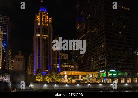 Chicago Tribune and Apple Michigan Avenue at night, Chicago, United States Stock Photo
