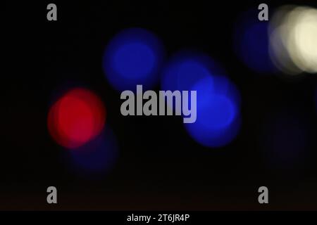 Bench and blur lights on dark background Stock Photo