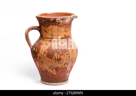 Antique earthenware jug with damaged paint on the surface. Traditional ukrainian culture Stock Photo