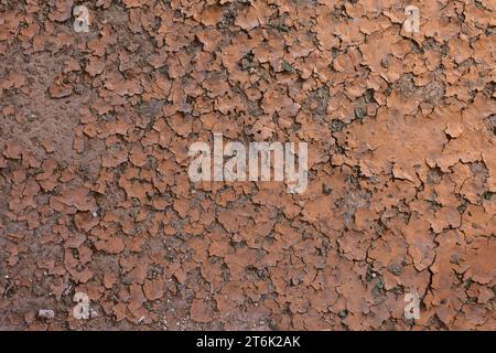 Flaking brownish paint on concrete floor surface. Stock Photo