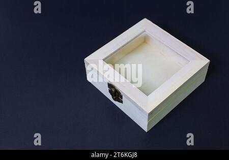 Empty small light brown wooden box Container objects are locked with separate latches on black background slots. Small handicrafts, bags, decorations, Stock Photo