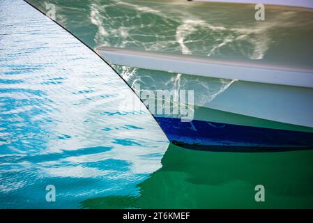The bow of a fishing boat reflecting the ripples Stock Photo