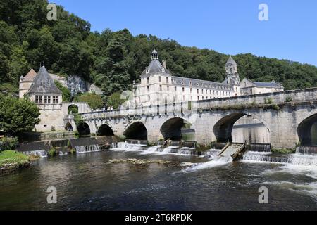 Brantôme in Périgord also called the Venice of Périgord because of the Dronne river which crosses it on all sides. Abbey embedded in the cliff, troglo Stock Photo