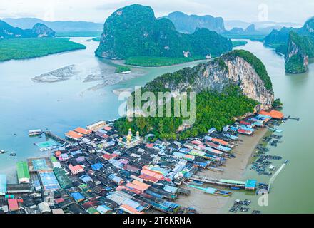 Aerial view Colorful house roofs on a village on Koh Panyee. amazing village on sea water. The natives densely planted their living quarters on the is Stock Photo