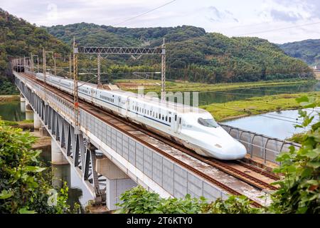 Kurashiki, Japan - October 1, 2023: Shinkansen N700 high-speed train operated by Japan Rail JR West on Sanyo Shinkansen line in Kurashiki, Japan. Stock Photo