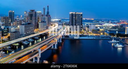 Kobe skyline from above with port and elevated road traffic panorama at twilight in Japan Stock Photo