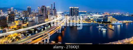 Kobe skyline from above with port and elevated road traffic panorama at twilight in Japan Stock Photo