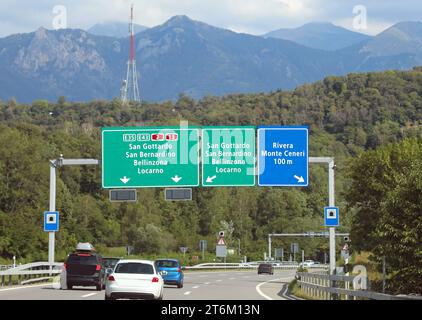 portal with road signs on the motorway with directions to many locations in Switzerland near the Italian border Stock Photo