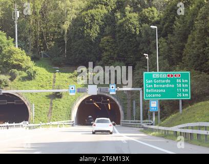 tunnel and road signs on the motorway with directions to many locations in Switzerland Stock Photo