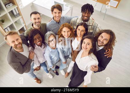Overhead view of smiling multiracial male and female colleagues and company employees. Stock Photo