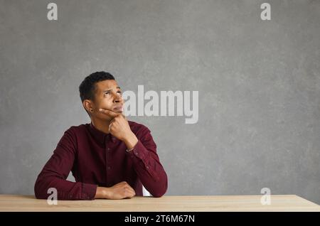African american employee, student or freelancer thinking sitting at desk Stock Photo