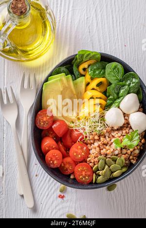 Fresh salad with buckwheat groats as fit food. Bowl with vegetables for fit people. Stock Photo