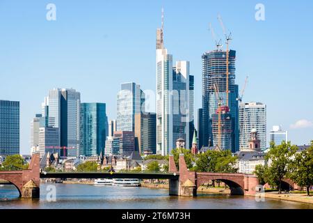 Skyscrapers of the financial district in Frankfurt am Main, Germany, with the "Four Frankfurt" buildings under construction and the Alte Brücke. Stock Photo
