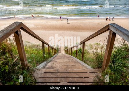 View to the seaside from old wooden stairs from a high coast on a sunny summer day in Jurkalne in Latvia, at the Baltic sea. Stock Photo