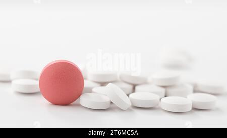Red and white pills on white background. Heap of assorted various medicine tablets and pills. Stock Photo