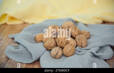 Food background. Walnut kernels close-up. Chopped nuts lie on a table. Stock Photo