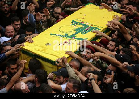 11 November 2023, Lebanon, Beirut: Pro-Iranian Hezbollah fighters chant slogans as they carry the coffin of their colleague, who was killed together with six other comrades during his funeral procession in Beirut's southern suburbs, in one of the party's highest death tolls in a single day. Since Hamas made a surprise attack on October 7th, more than 60 Hezbollah fighters have been killed. Photo: Marwan Naamani/dpa Stock Photo